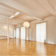 lichtdurchfluteter klarer Yogaraum im Zen Stil mit Holzboden